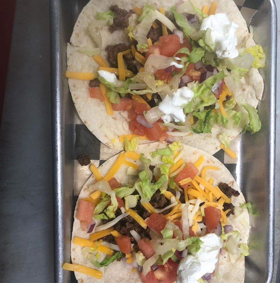Two tacos from Roccos in a metal dish.