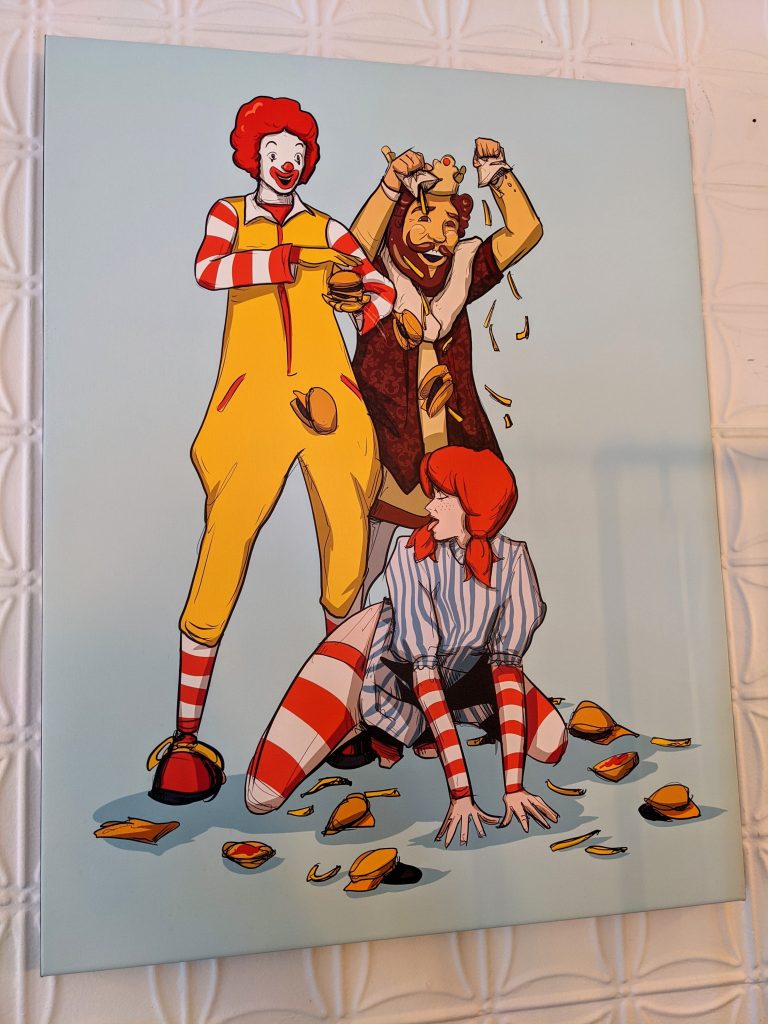 Large wall mounted caricature of Ronald McDonald and the Burger King sprinkling French fries over a low, provocatively dancing Wendy.
