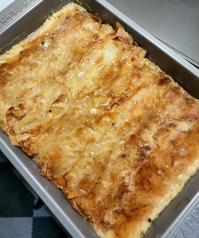 Birds eye view of a finished pan of Phyllo Tres Leches with a glazed cooked top.