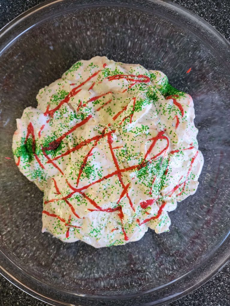 Birds eye view of decorated Christmas tree dip in a glass bowl.