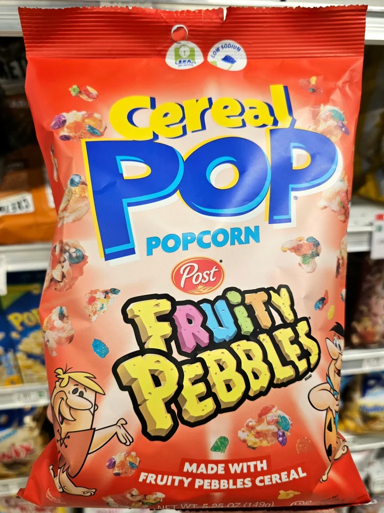 Front package of Pop Cereal Fruity Pebbles Popcorn bag.