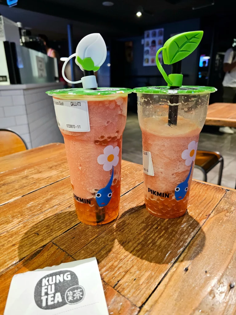 Two cups of Pikmin Kung Fu Tea Fruit Slushes with Pikmin straw caps.