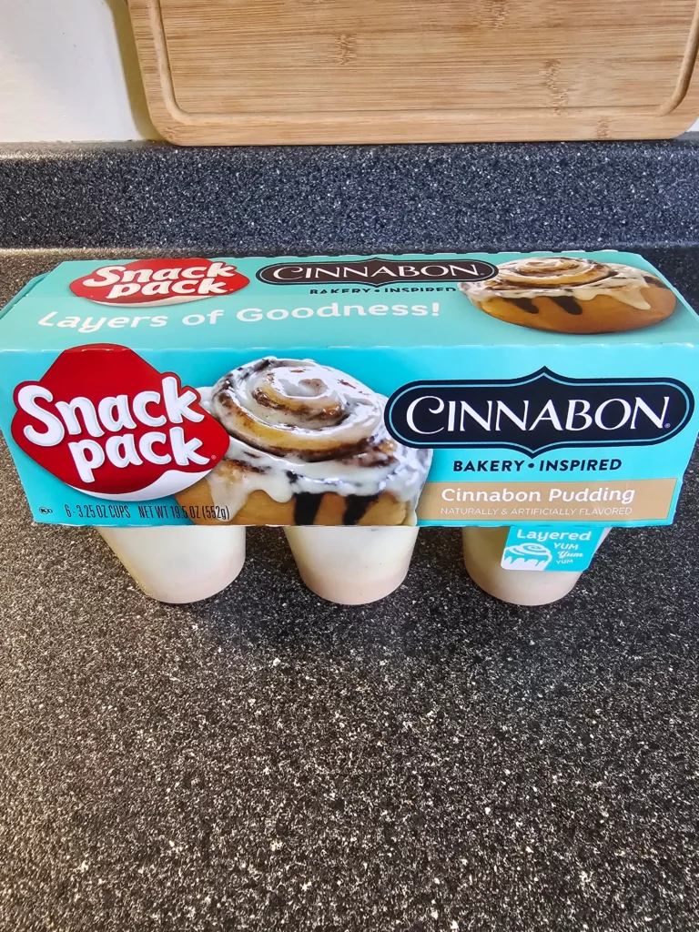 Front and top of 6 pack of Snack Pack Cinnabon Pudding.