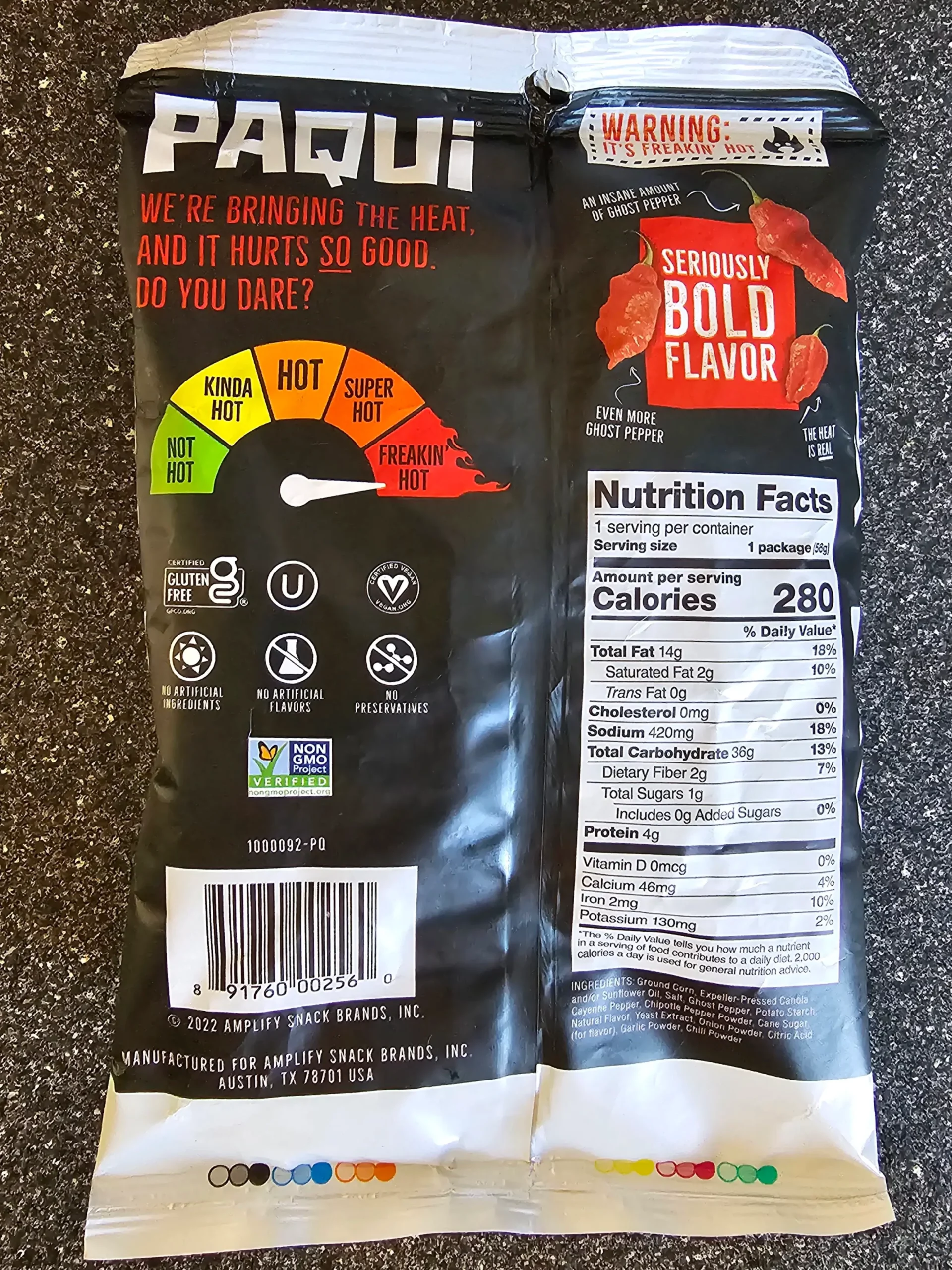Front package, including ingredients and nutrition label, of Paqui Haunted Ghost Pepper Spicy Chips.