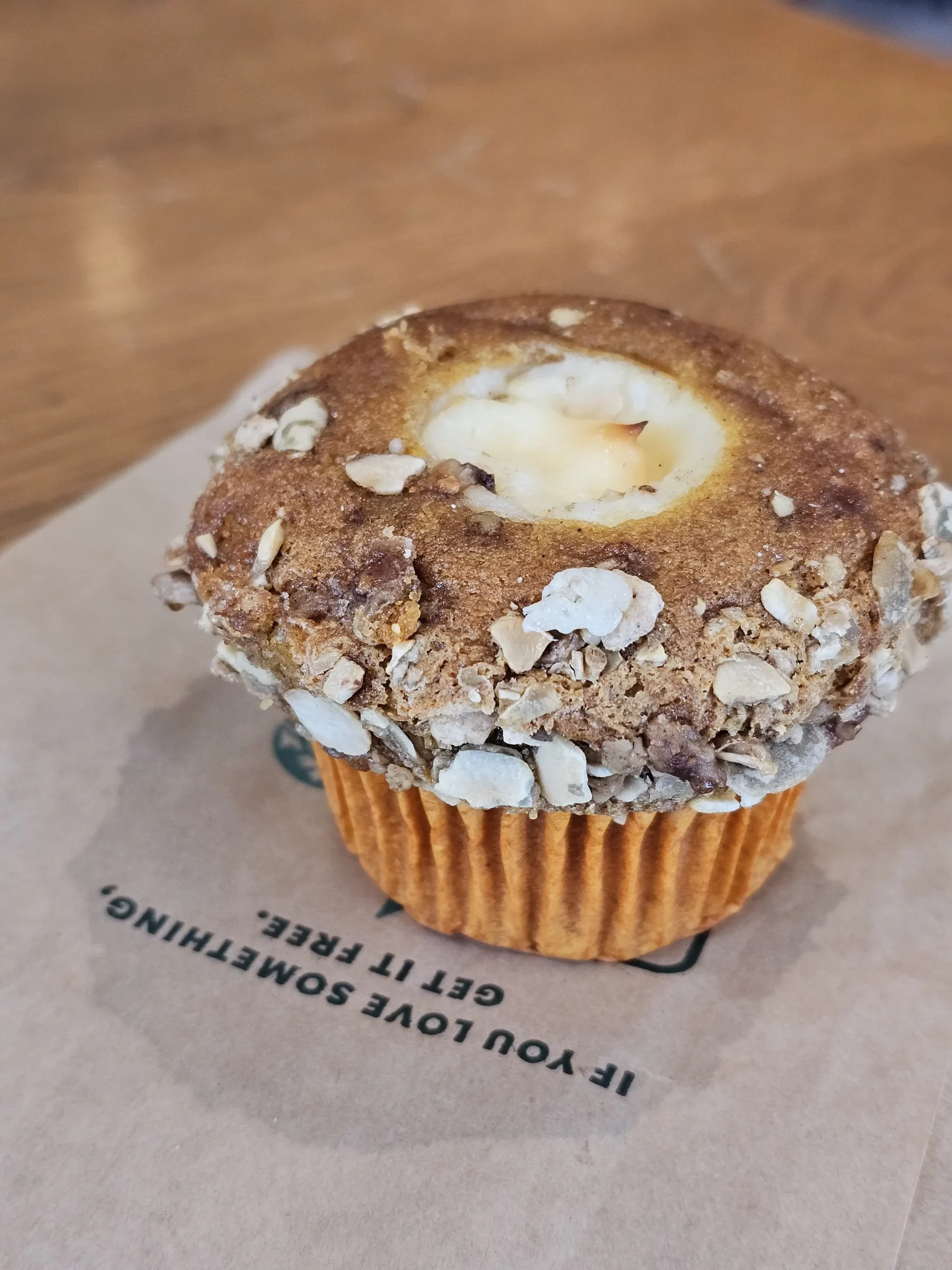 Starbucks Pumpkin Cream Cheese Muffin on a table.
