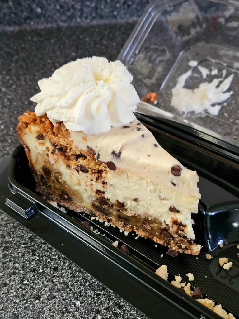 Slice of Cheesecake Factory 2023 Limited Edition Cookie Dough Lover's Cheesecake with Pecans.