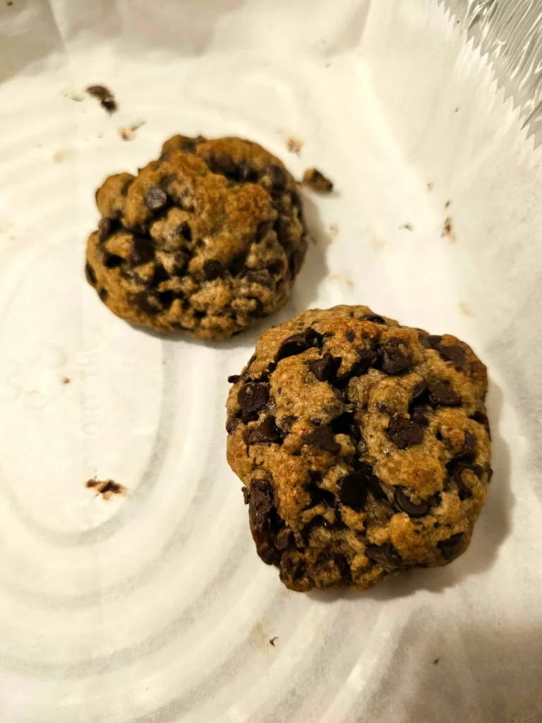 Two mini Nutella stuffed Levain cookies in a serving container.