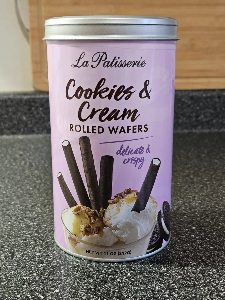 Front container of La Patisserie Cookies & Cream Rolled Wafers.