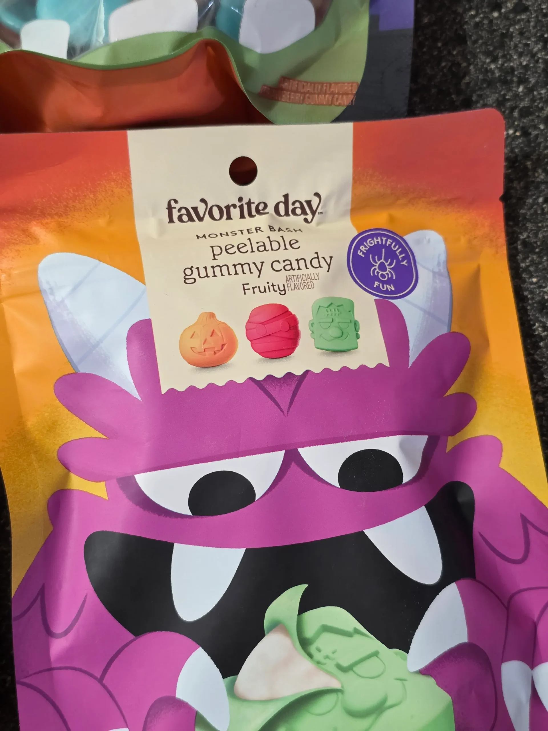Target Favorite Day Halloween Gummy Candy: Enchanted Queen Peelable Apple & Sour Green Apple, Witch Hats and Wands, Halloween Monster Bash Peelable Fruity, Strawberry Gummy Candy Brains, and Fruity Sour Freeze-Dried Candy Worms.