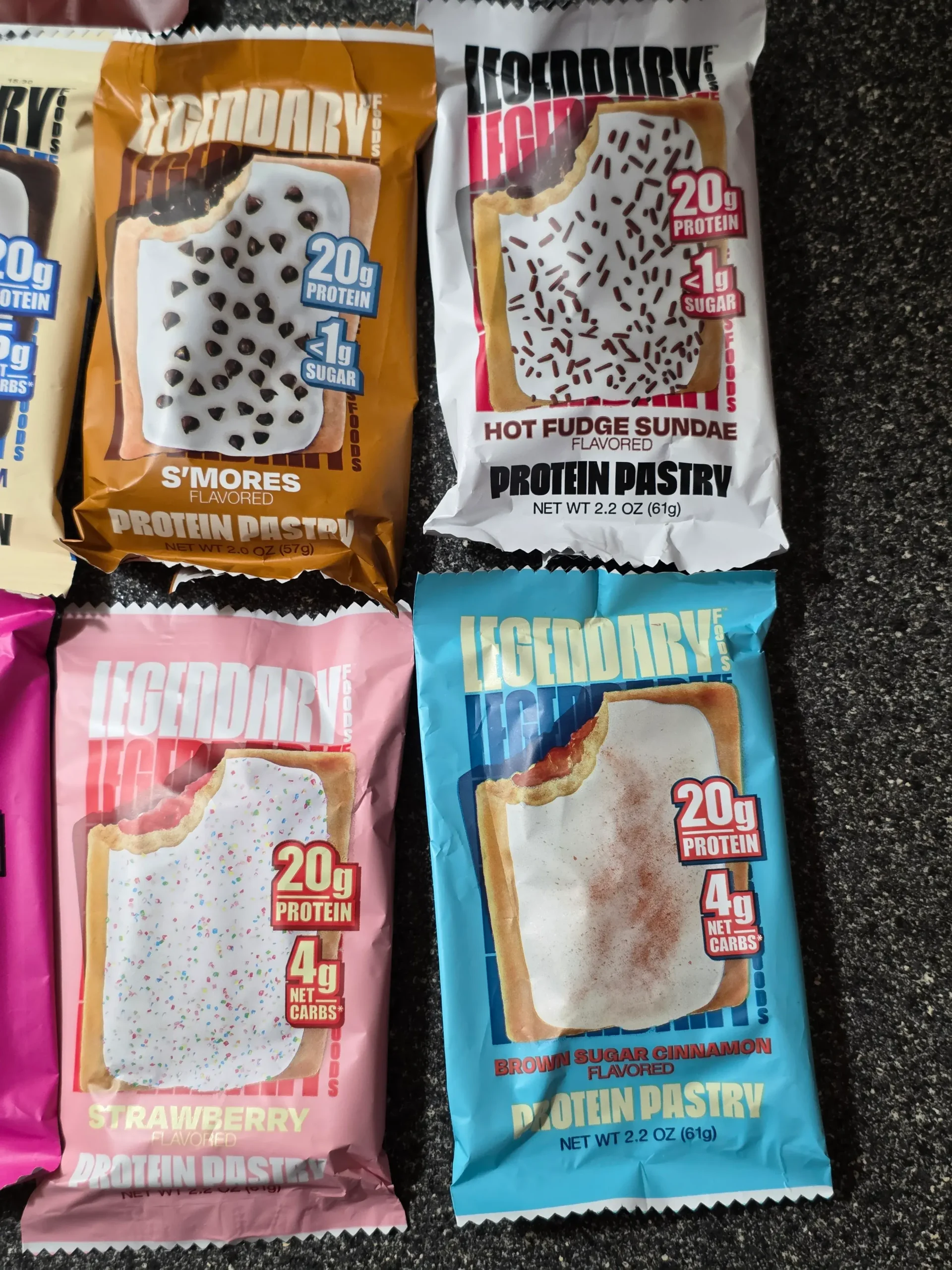 Legendary Foods Cake Style Protein Pastry "Pop-Tarts": Chocolate Cake, Cherry Crumble, Cookies & Cream, S'mores, Hot Fudge Sundae, Blueberry, Birthday Cake, Strawberry, and Brown Sugar Cinnamon.