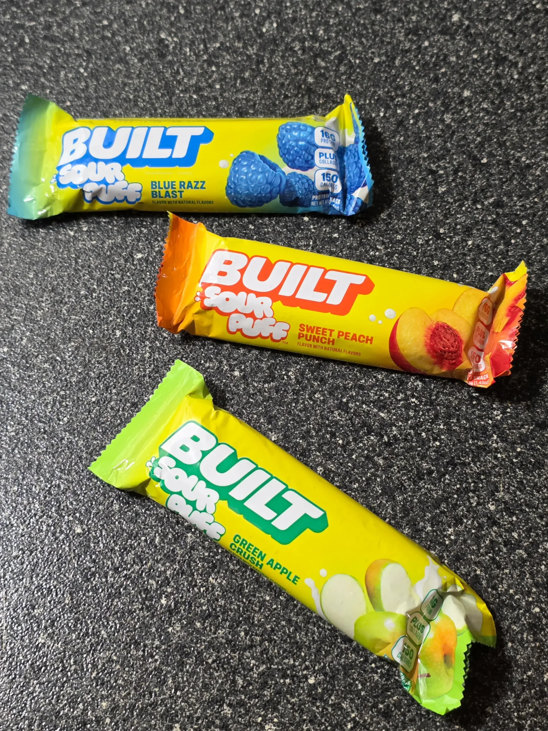 Built Sour Puff Protein Bars: Blue Razz Blast, Sweet Peach Punch, and Green Apple Crush.
