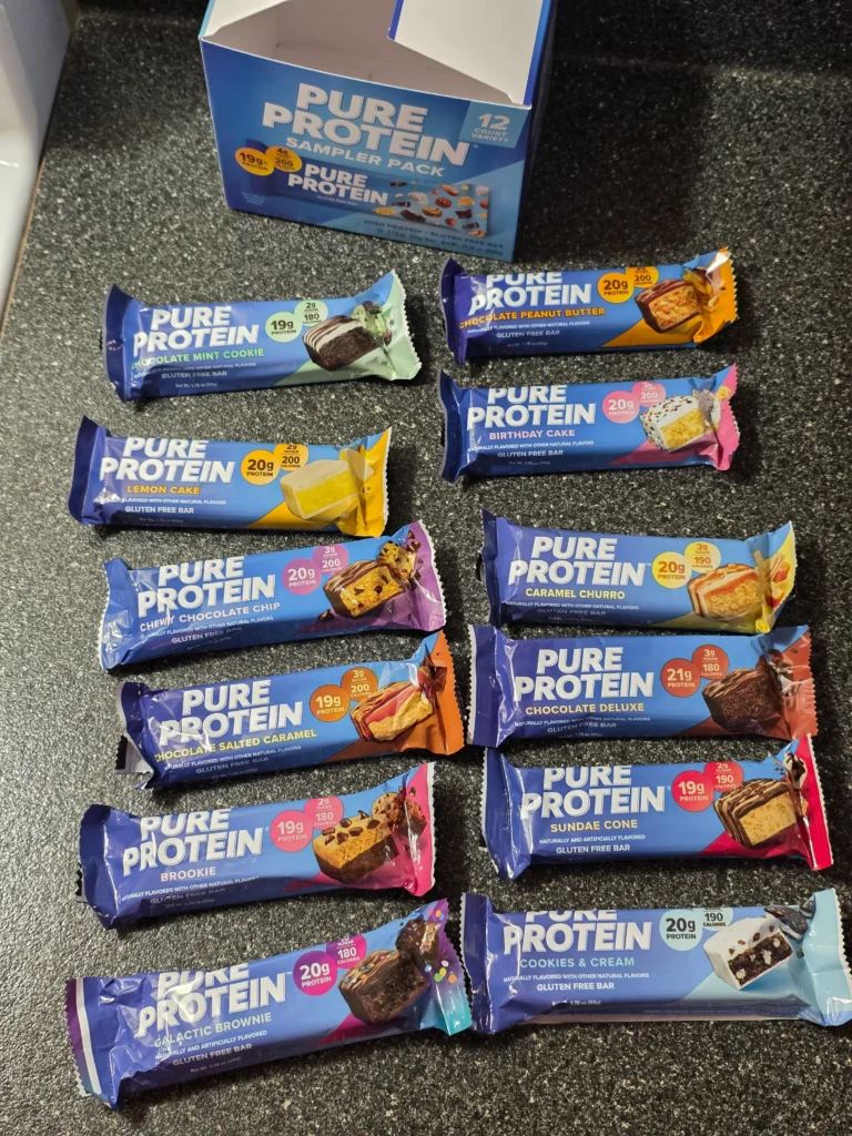 Pure Protein Bar Variety Pack: Chocolate Peanut Butter, Birthday Cake, Caramel Churro, Chocolate Deluxe, Sundae Cone, Cookies & Cream, Galactic Brownie, Brookie, Chocolate Salted Caramel, Chewy Chocolate Chip, Lemon Cake, and Chocolate Mint Cookie.