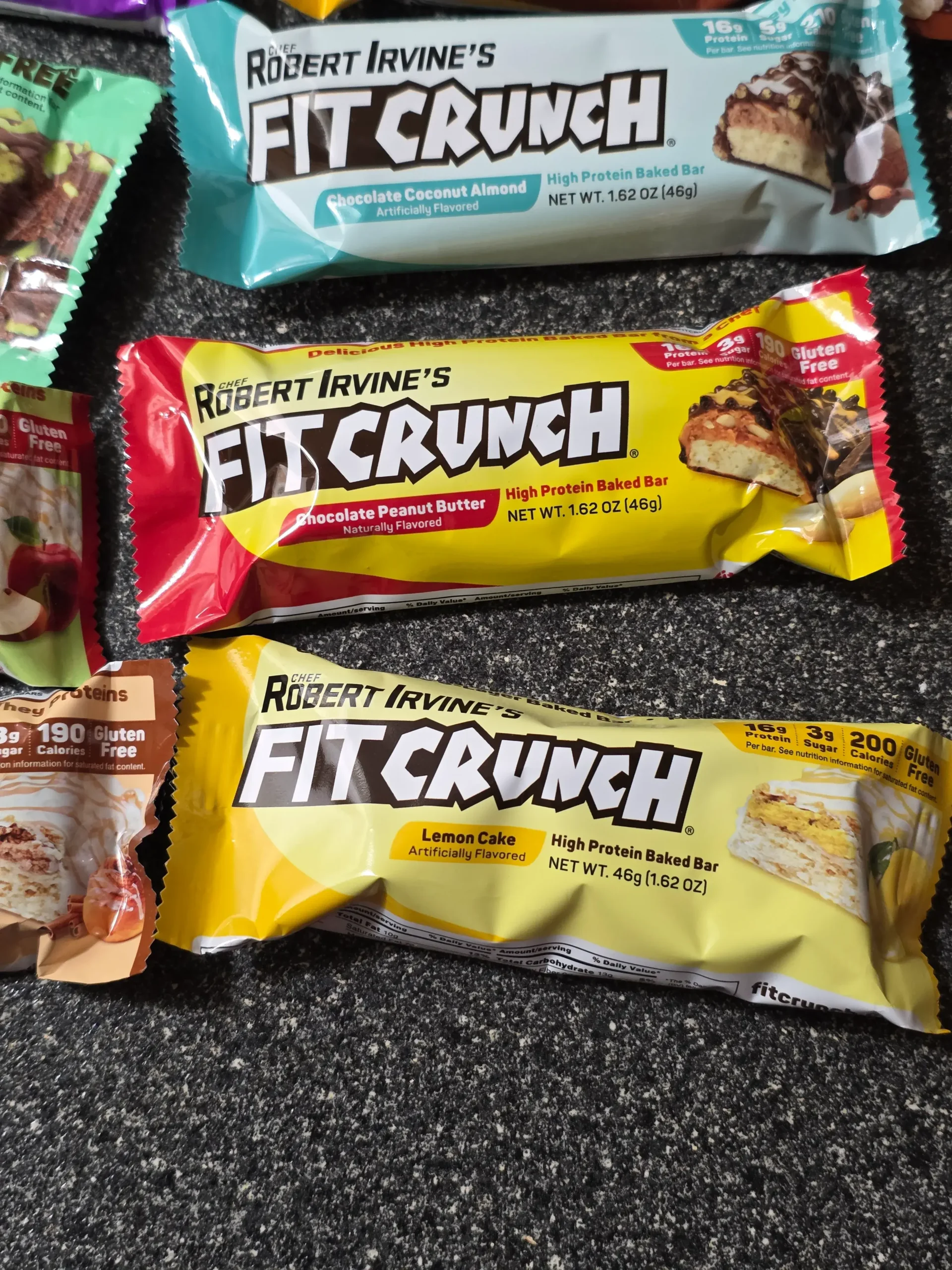 Robert Irvine's FITCRUNCH Protein Bars, including Flavor Lover's Variety pack: Chocolate Peanut Butter, Chocolate Banana, Chocolate Chip Cookie Dough, Chocolate Brownie, Chocolate Coconut Almond, Cinnamon Twist, Milk & Cookies, Lemon Cake, Apple Pie, and Mint Madness Loaded Cookie.