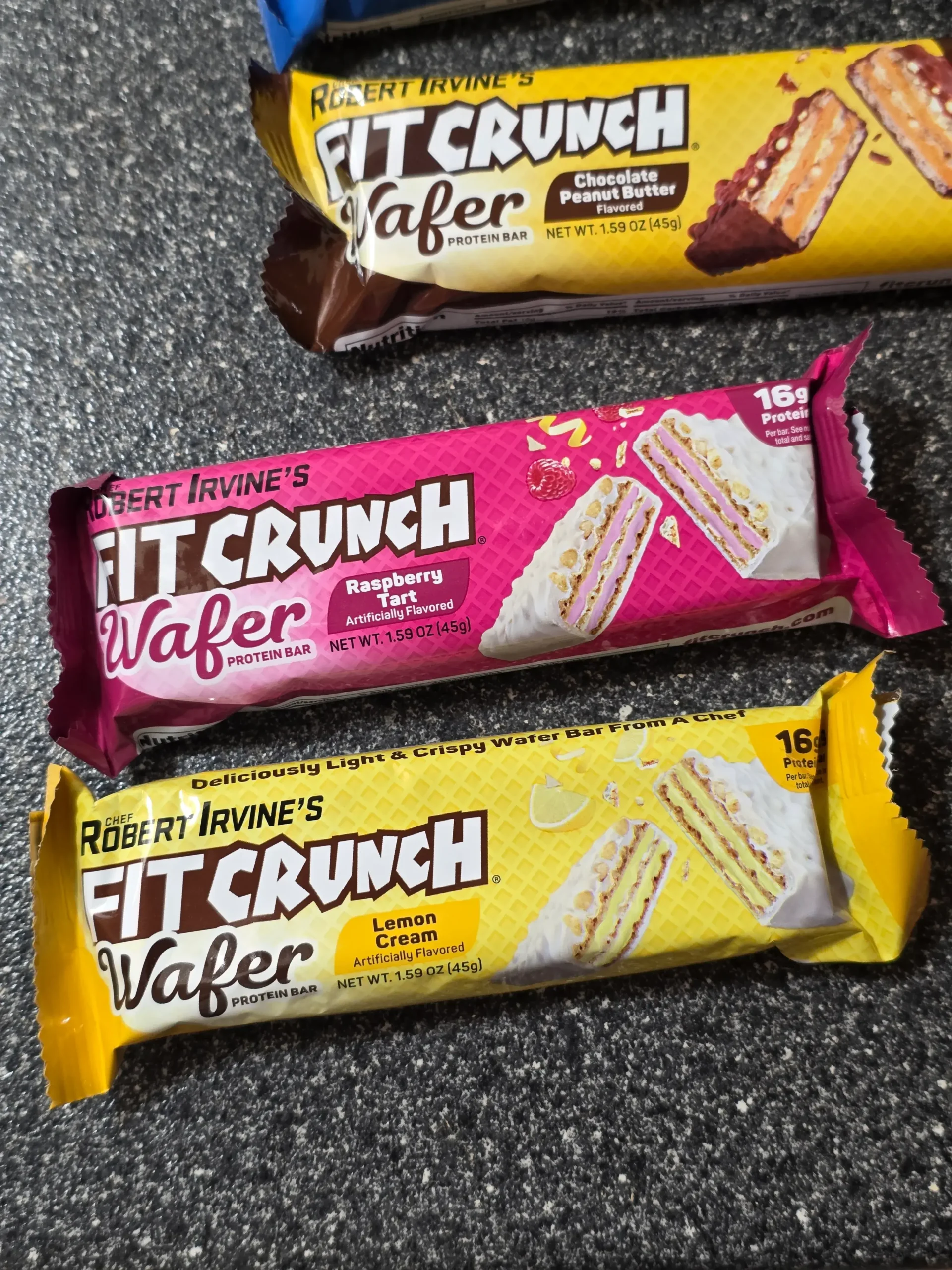 Robert Irvine's FITCRUNCH Variety Pack: Vanilla Gelato, Chocolate Peanut Butter, Raspberry Tart, and Lemon Cream.