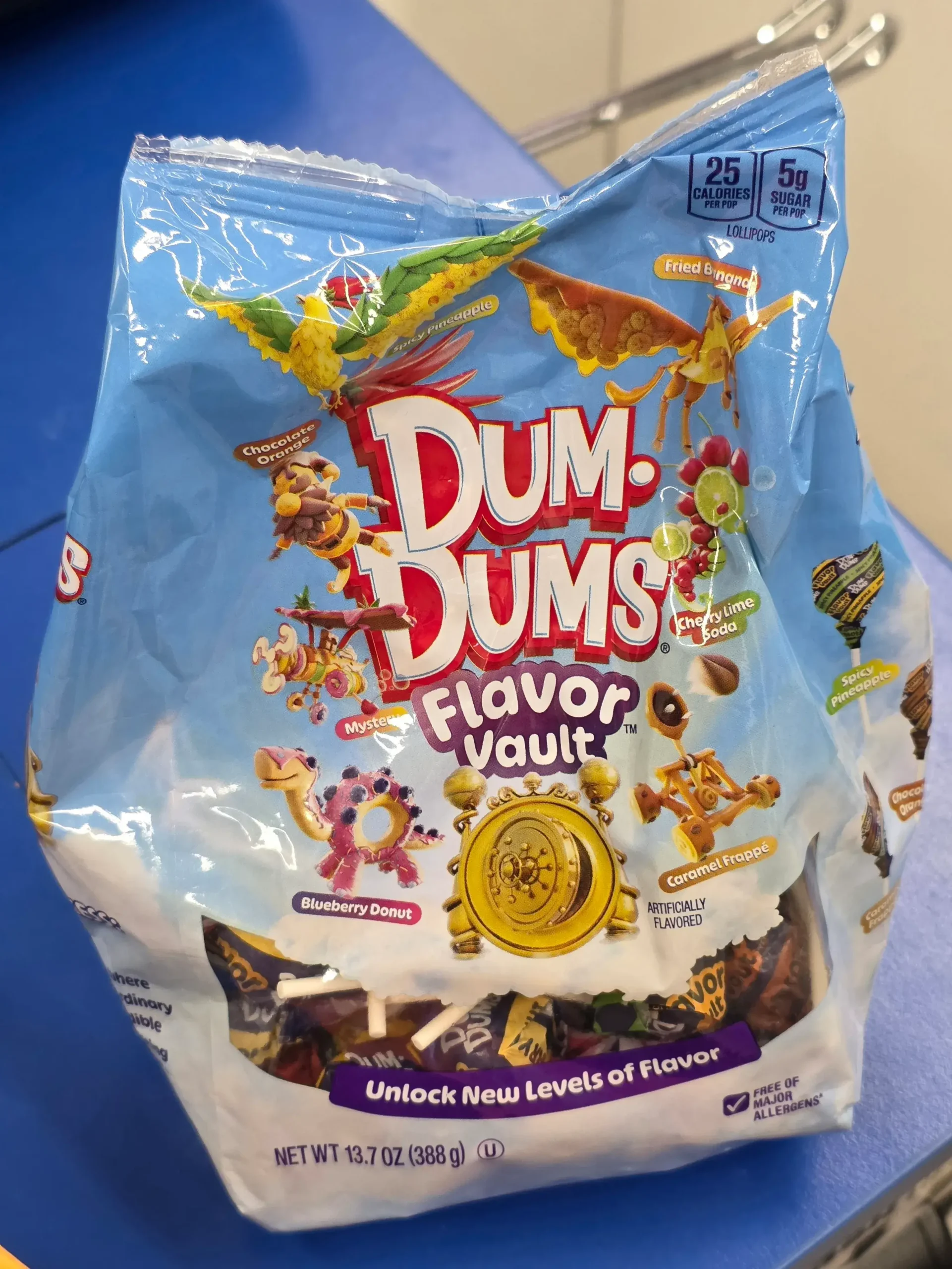 Dum-Dums Flavor Vault: Fried Banana, Cherry Lime Soda, Blueberry Donut, Mystery, Caramel Frappe, Chocolate Orange, and Spicy Pineapple.