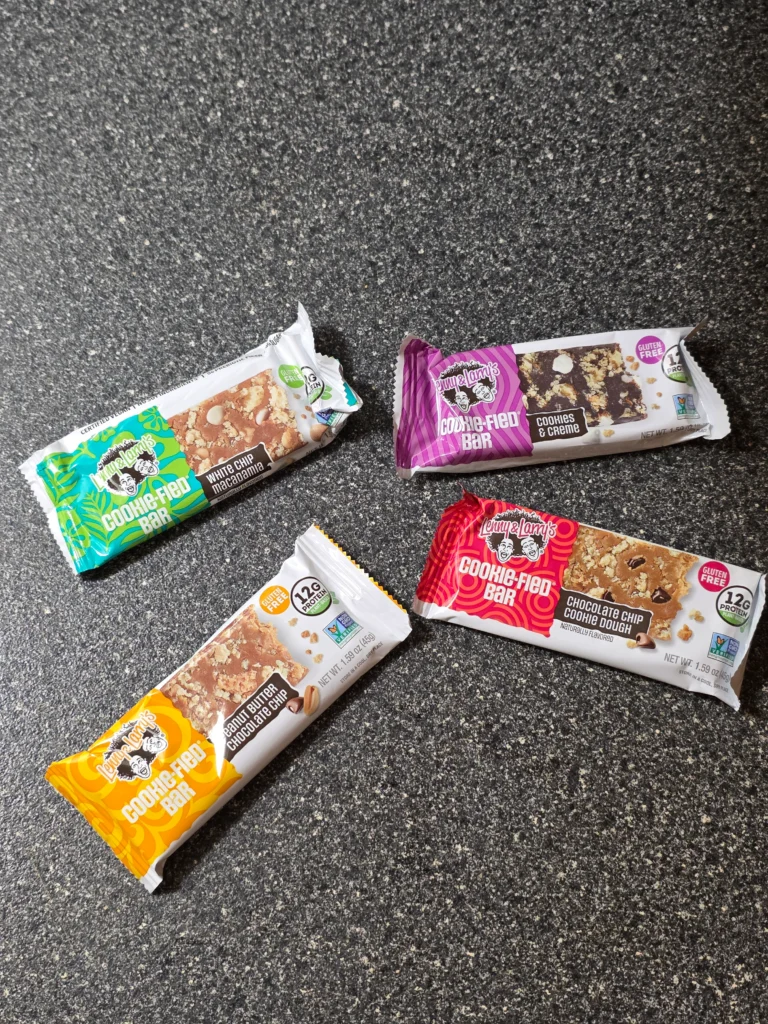 Lenny & Larry's Cookie-fied plant-based Protein Bar Variety Pack: Chocolate Chip Cookie Dough, Cookies & Creme, Peanut Butter Chocolate Chip, and White Chip Macadamia.