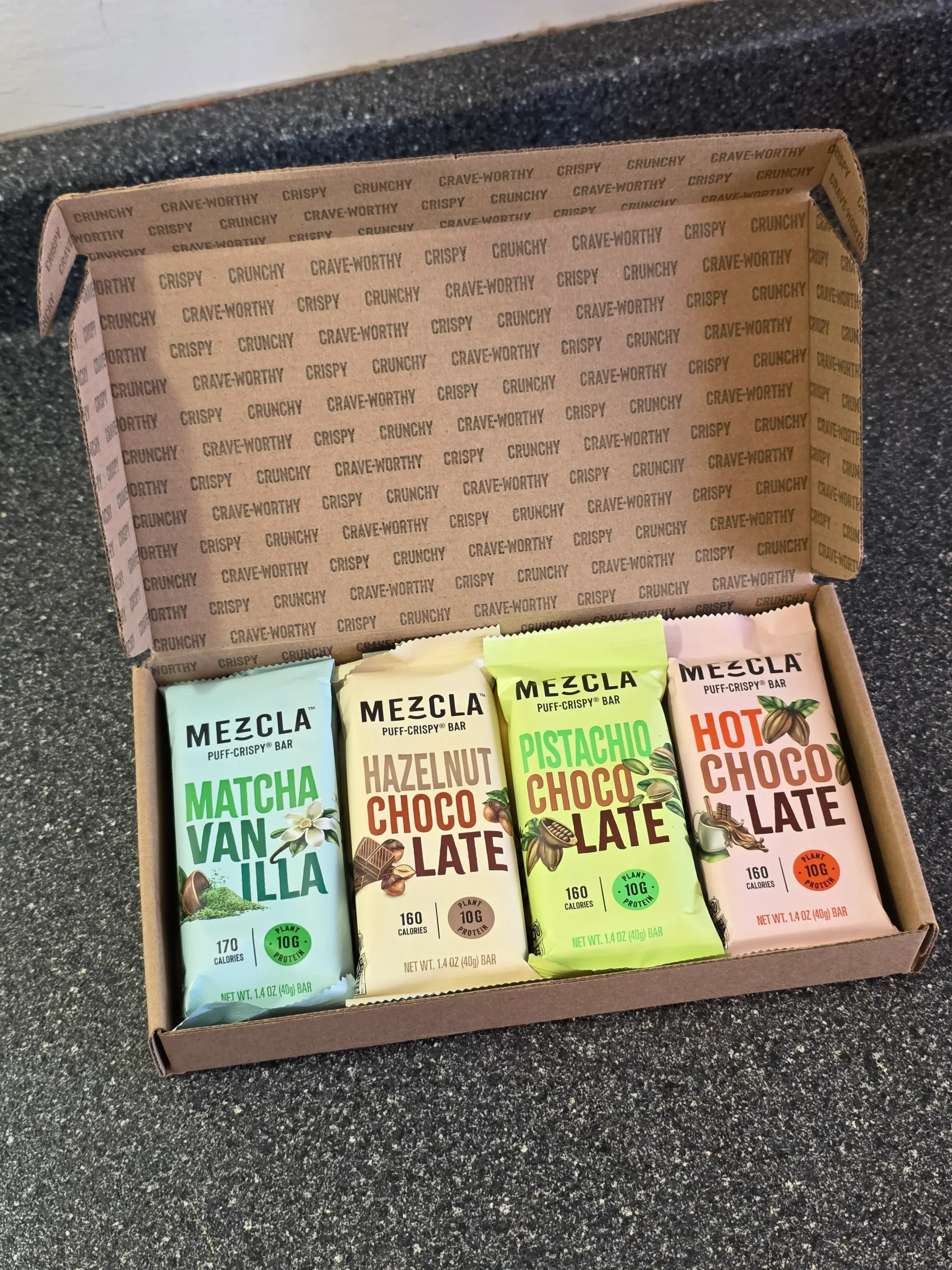 Mezcla Puff-Crispy Plant-Based Protein Bars Variety Pack: Peanut Butter Chocolate, Hot Chocolate, Pistachio Chocolate, Maple Blueberry, Hazelnut Chocolate, Almond Butter Chocolate, and Matcha Vanilla.
