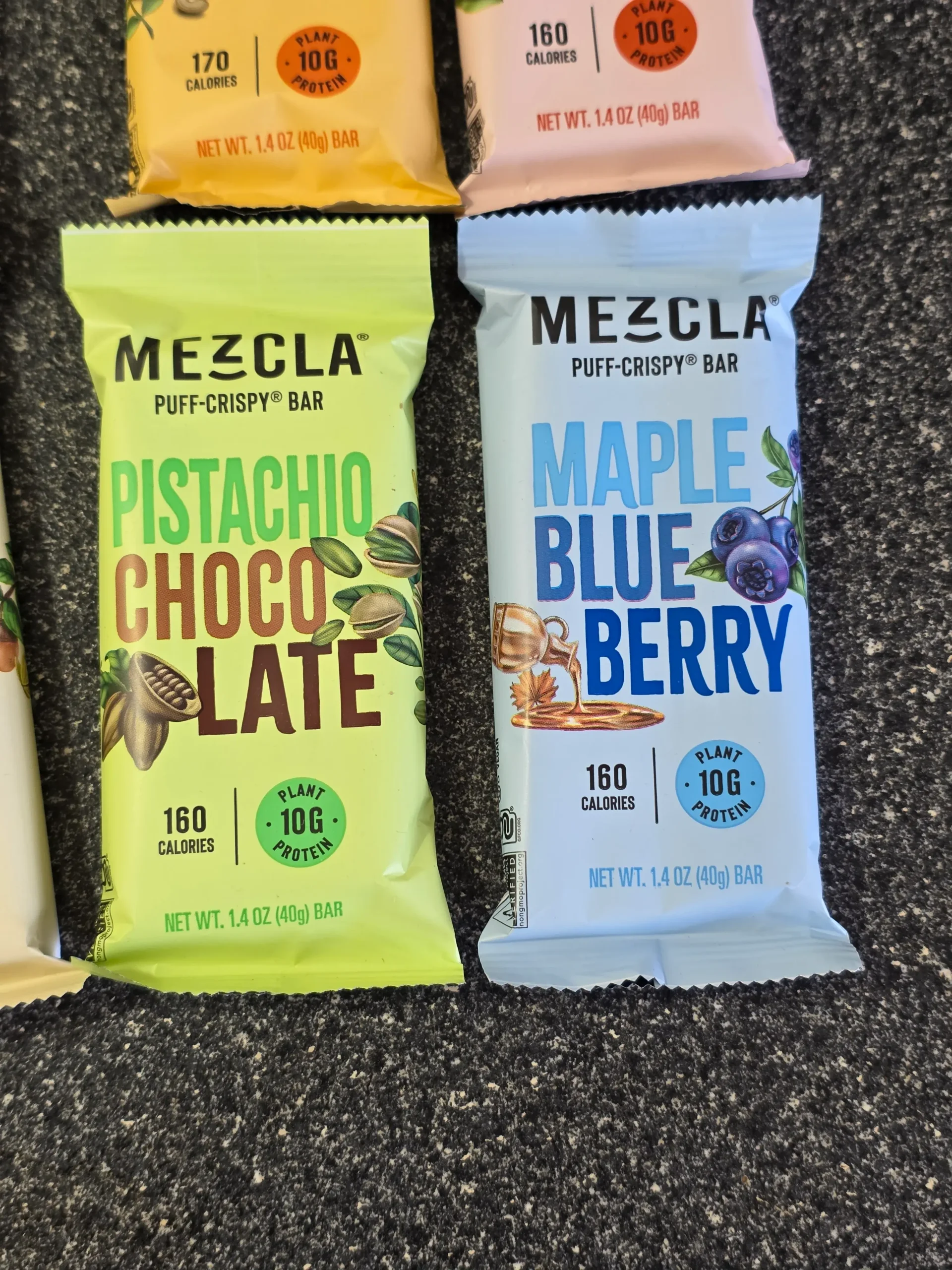 Mezcla Puff-Crispy Plant-Based Protein Bars Variety Pack: Peanut Butter Chocolate, Hot Chocolate, Pistachio Chocolate, Maple Blueberry, Hazelnut Chocolate, Almond Butter Chocolate, and Matcha Vanilla.