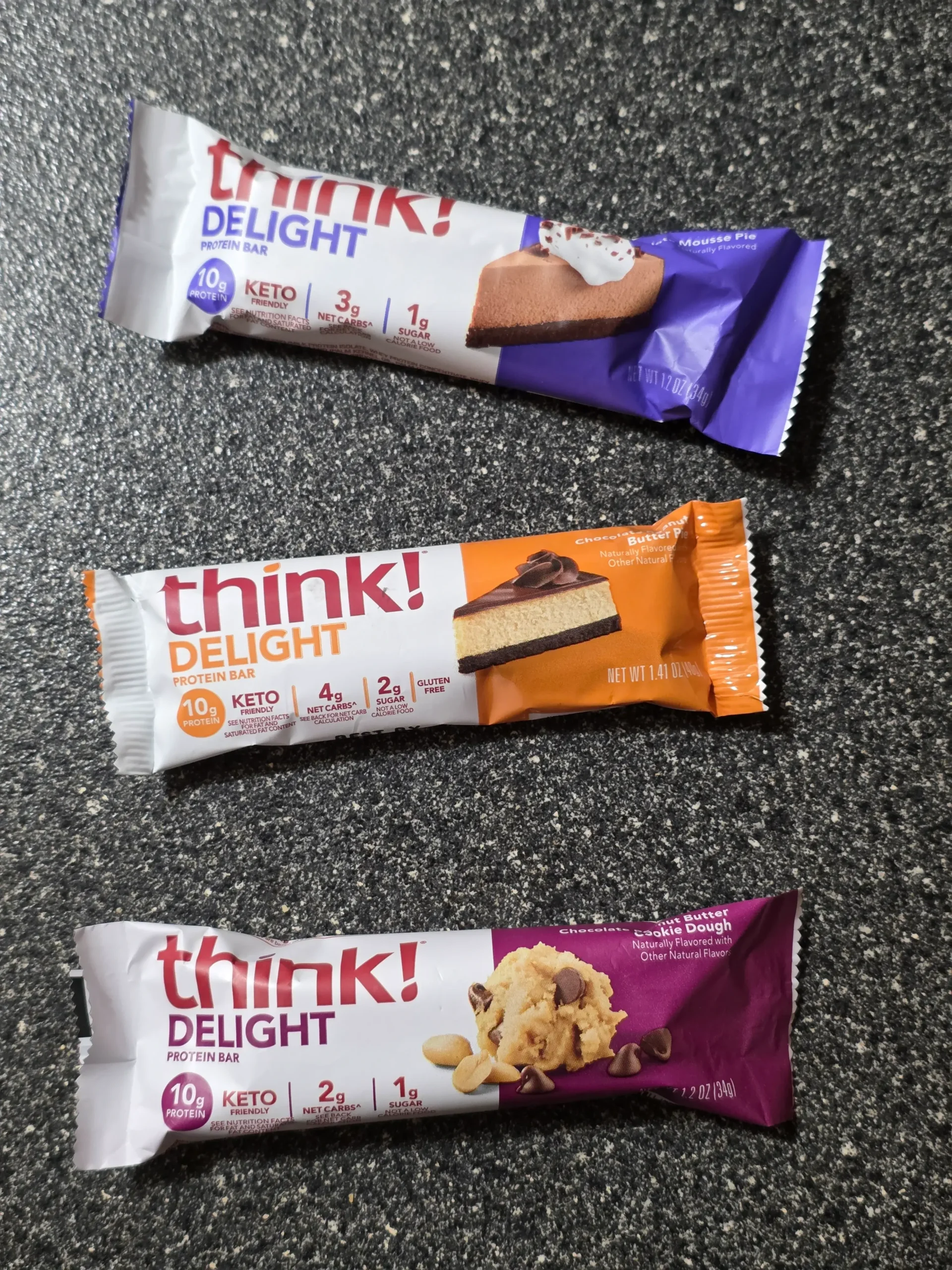 think! Delight protein bars, Chocolate Peanut Butter Cookie Dough, Chocolate Peanut Butter Pie, and Chocolate Mousse Pie.