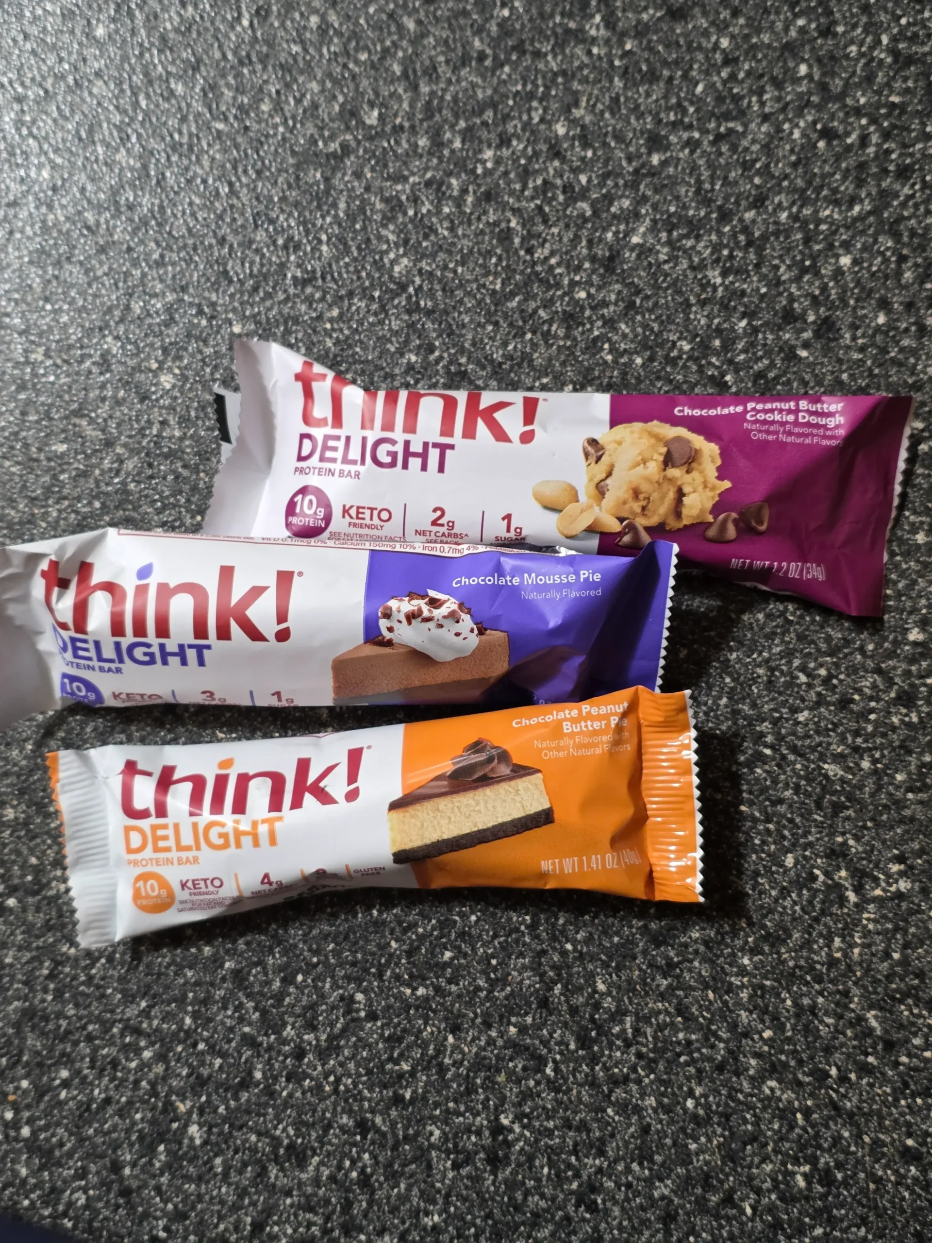 think! Delight protein bars, Chocolate Peanut Butter Cookie Dough, Chocolate Peanut Butter Pie, and Chocolate Mousse Pie.