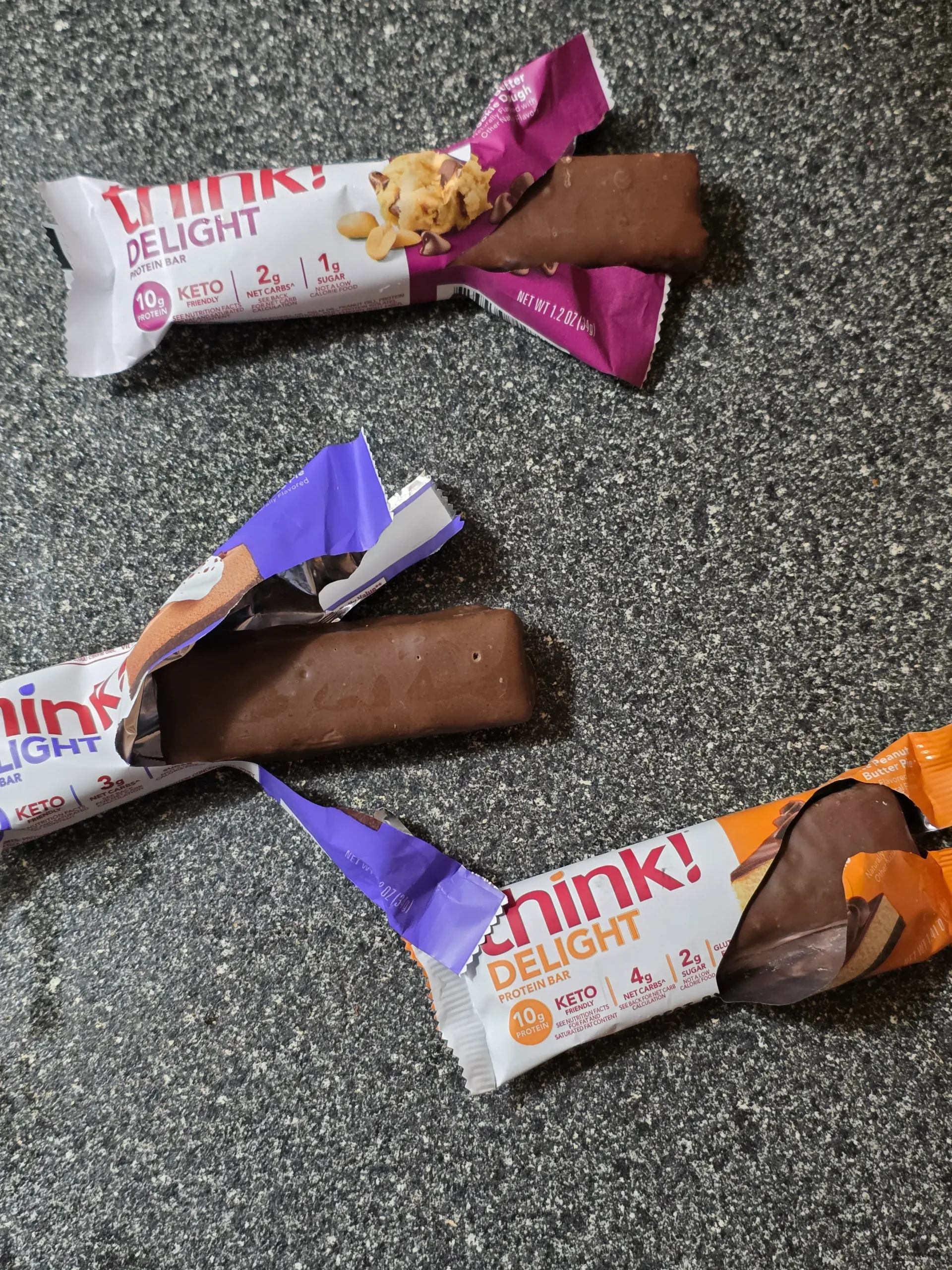 think! Delight protein bars, Chocolate Peanut Butter Cookie Dough, Chocolate Peanut Butter Pie, and Chocolate Mousse Pie.