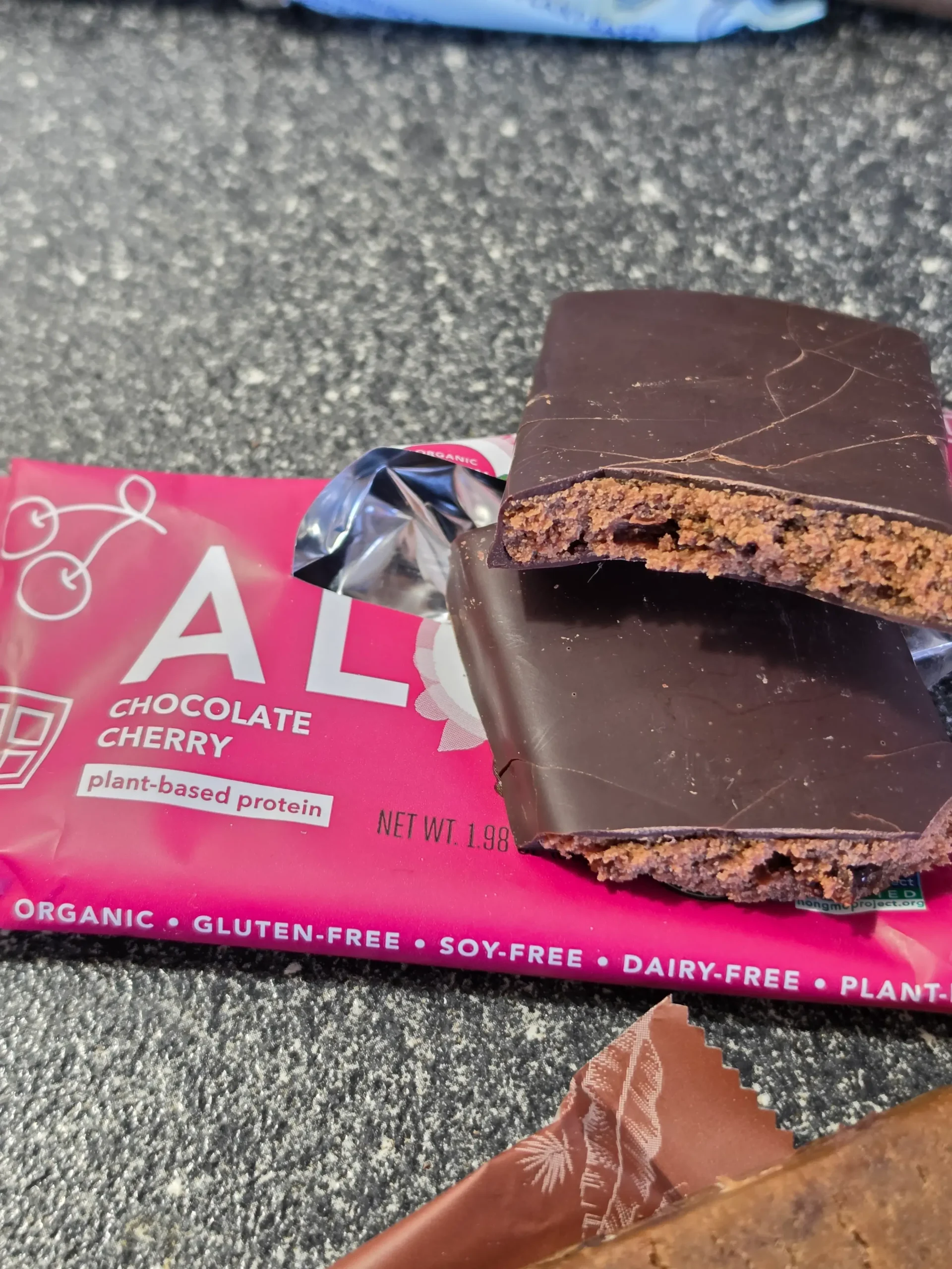 Aloha Plant-Based Protein Bars, Blueberry, Chocolate Cherry, Chocolate Chip Cookie Dough, Chocolate Caramel Pecan, Peanut Butter Chocolate Chip, Maple Sea Salt, and Coconut Chocolate Almond.