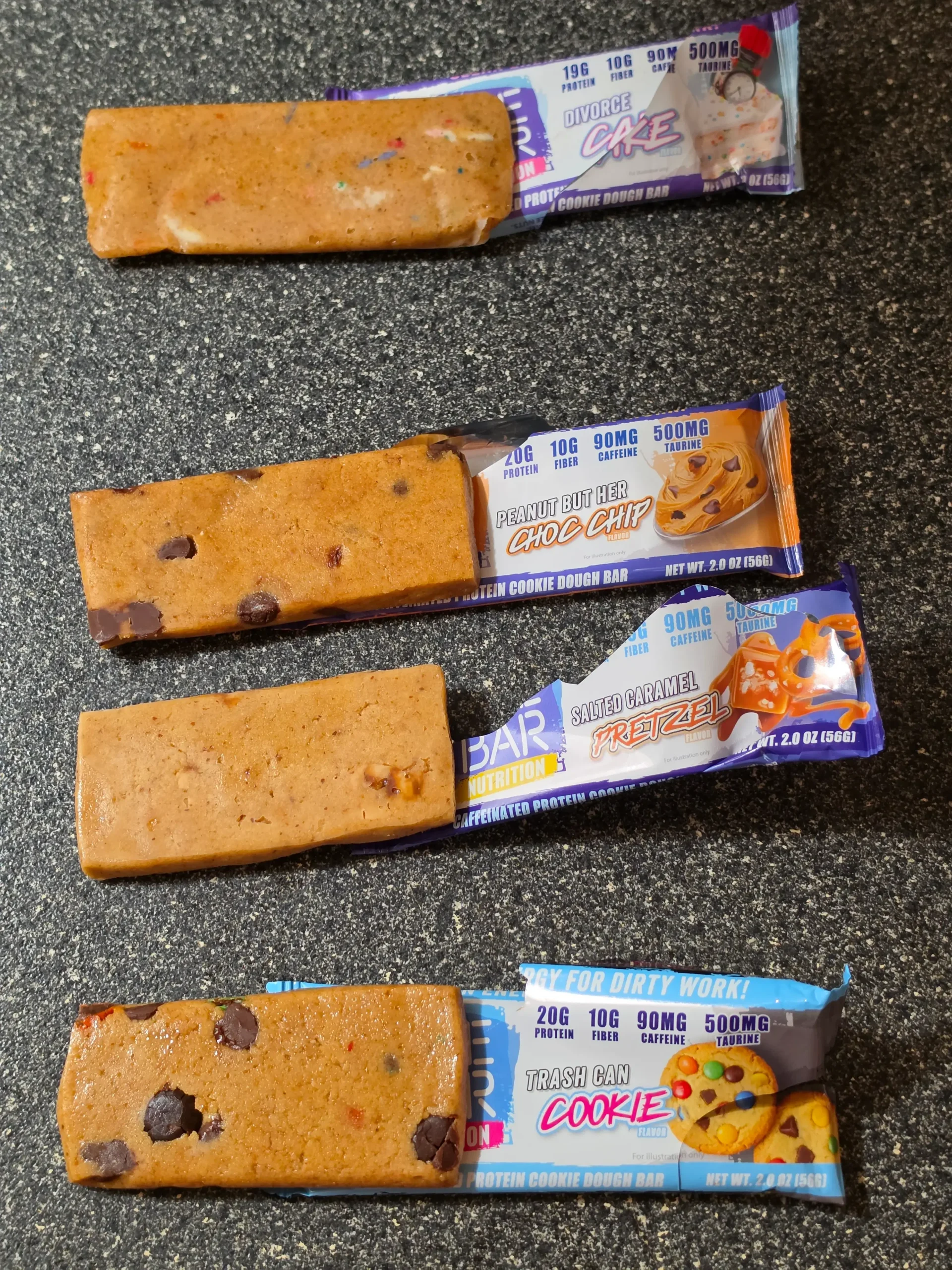 Dive Bar four-bar variety pack. Flavors: Trash Can Cookie, Salted Caramel Pretzel, Peanut But Her Chocolate Chip, and Divorce Cake.