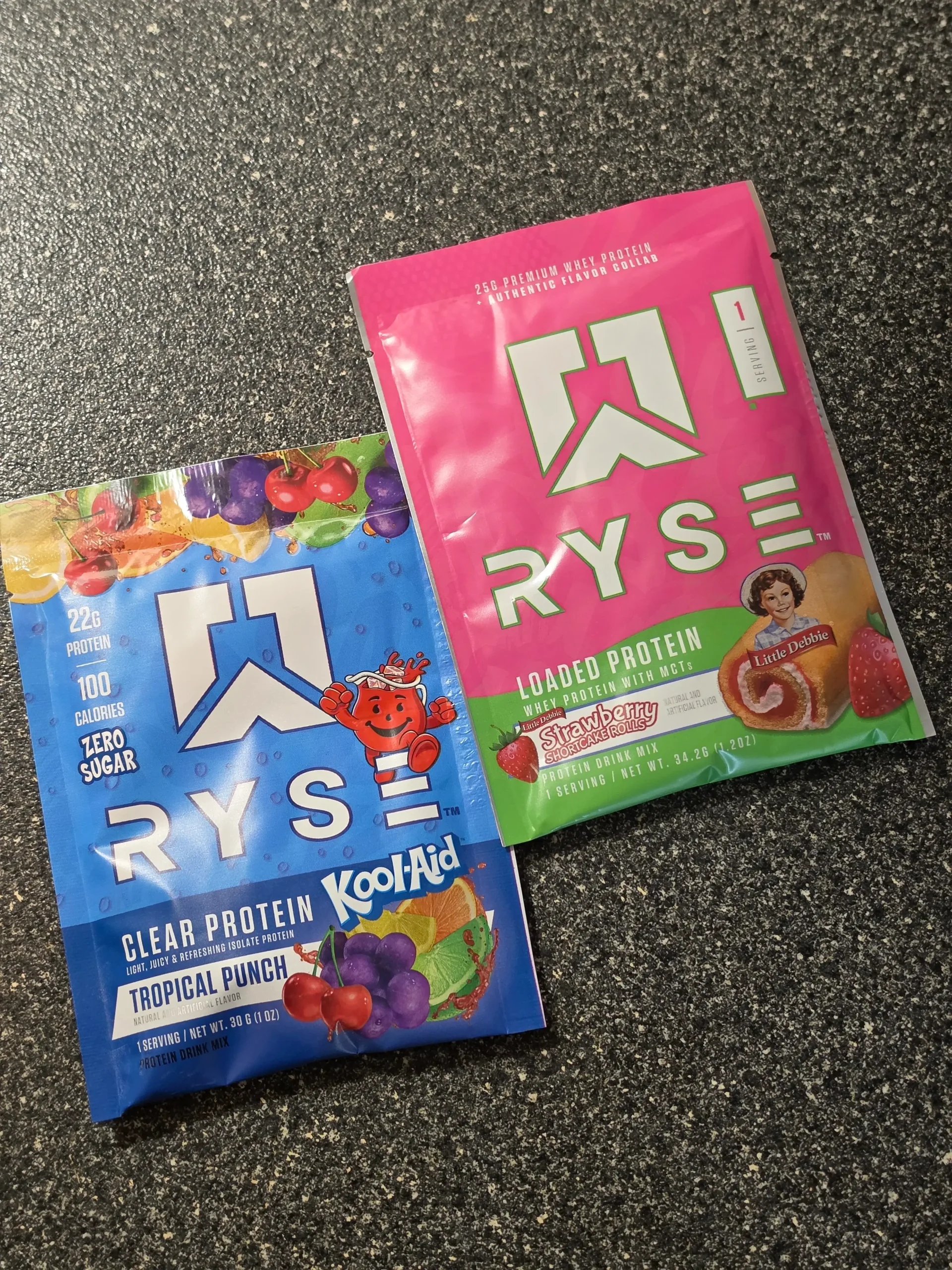 Ryse protein variety pack: Kool-Aid Tropical Punch, Country Time Lemonade, Cinnamon Toast, Little Debbie Cosmic Brownie, Jet-Puffed Marshmallow, Little Debbie Strawberry Shortcake Rolls.